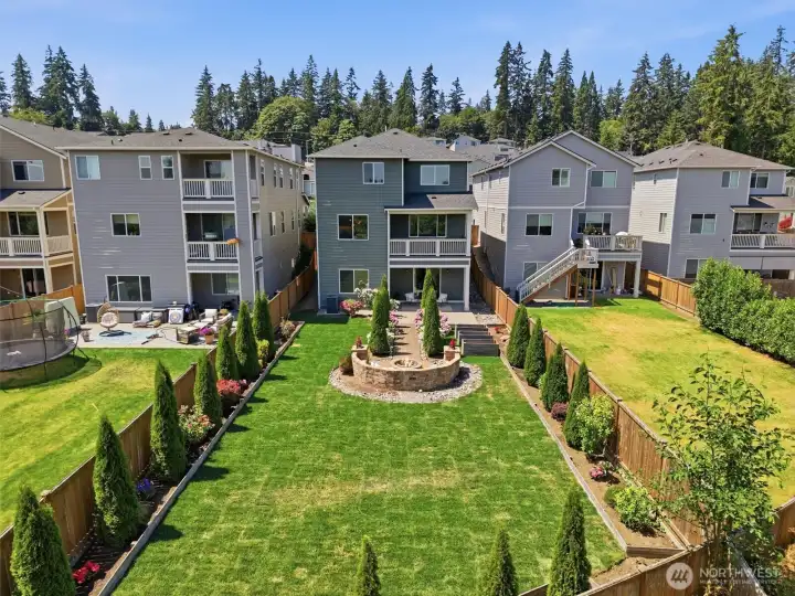 Aerial view showcasing the backyard and surrounding community.