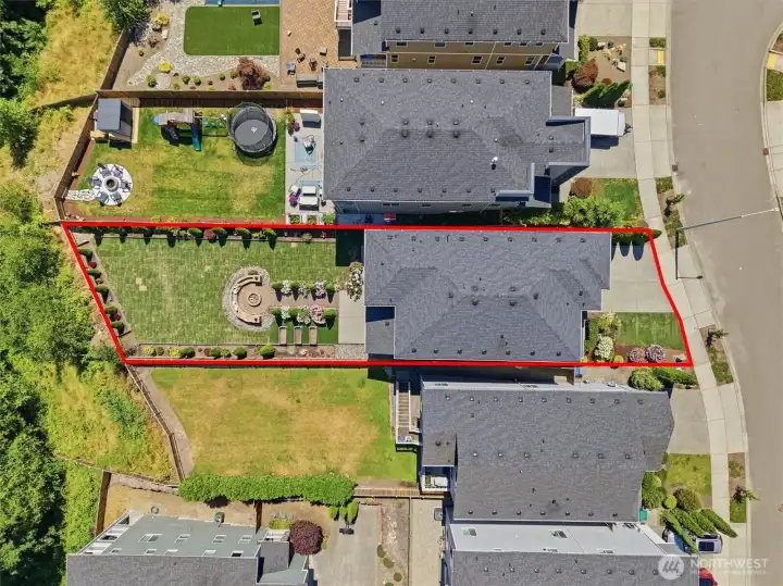 Bird's-eye view highlighting the home's lot and outdoor living spaces.