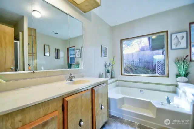 Primary bathroom, featuring a soak-in tub and a separate walk-in shower for your convenience and relaxation.