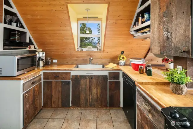 You will love the rustic feel of this cabin kitchen. Wood butcher block counters, dishwasher, stove and refrigerator included.