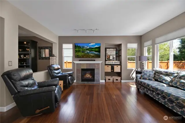 Family room with a gas fireplace and wonderful views of the backyard & greenbelt.