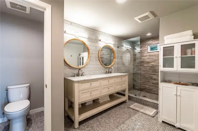 The beautifully remodeled primary bathroom has heated flooring.