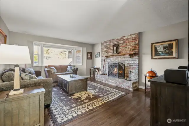 Formal Livingroom with wood burning fireplace and large bay window. All windows are new.