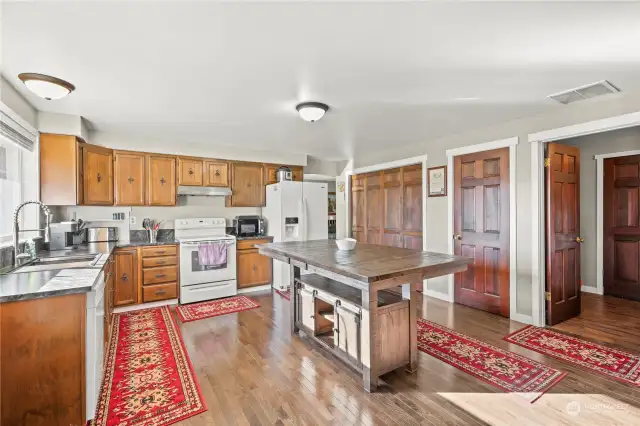 Kitchen with new counter top, sink and faucet. Lots of cabinets pantry and large island breakfast bar.