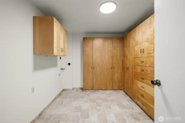 Huge Laundry room accommodates a full size washer and dryer and More Storage!