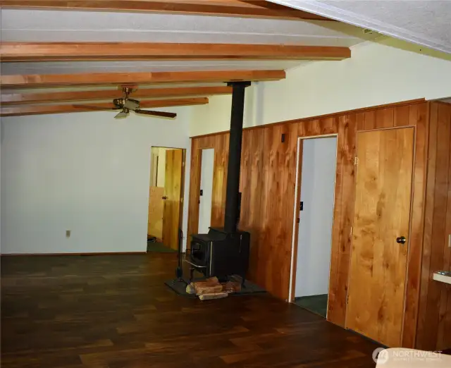 Family room with wood stove and access to all 3 bedrooms.