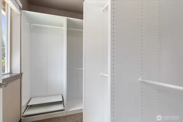 Primary bedroom closet with Ikea organizer system.