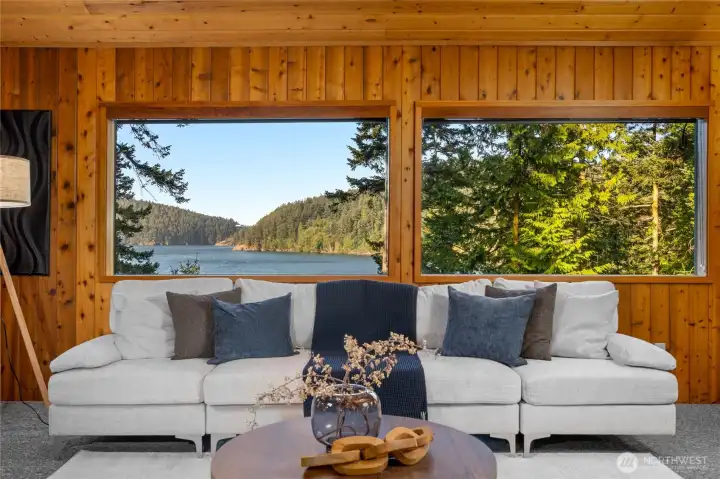 Knotty pine tongue and groove wall and ceiling panneling with skylights and picture windows throughout the space.