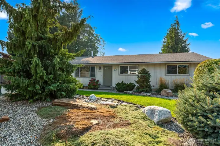 Charming one-level home with lush landscaping, new roof, and full irrigation.