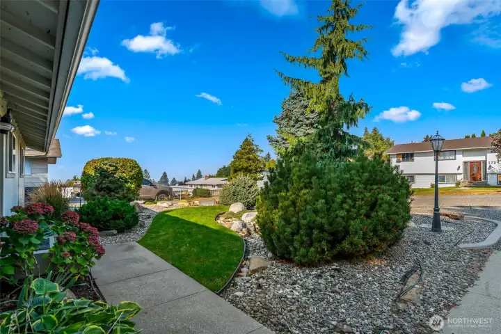 Inviting front entry with a charming yard and view.