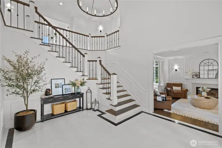 Front entry with marble flooring, custom railing, high end fixtures and lighting and coffered ceilings will leave you speechless.