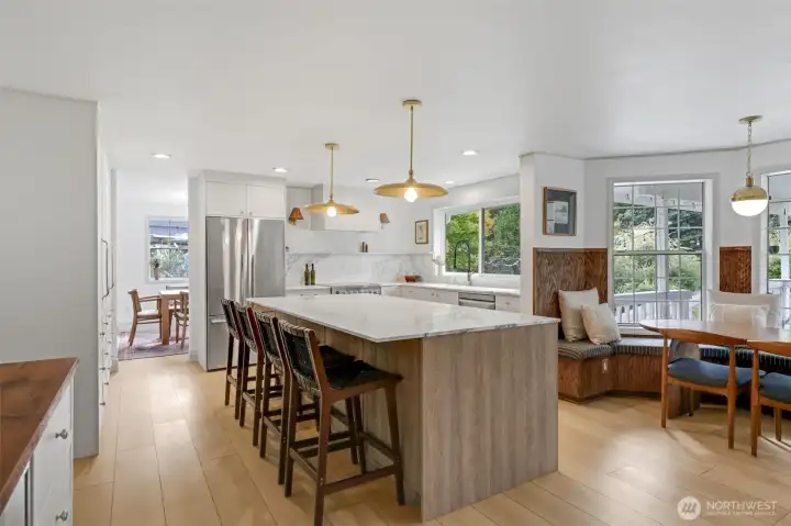 A spacious center island anchors the kitchen, offering abundant storage and generous seating—perfect for gathering, meal prep, and everyday living.