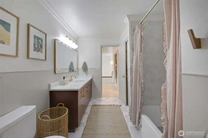 A fully updated hall bathroom conveniently located next to the bedrooms, featuring a stylish new vanity, modern fixtures, and a clean, refreshed design.