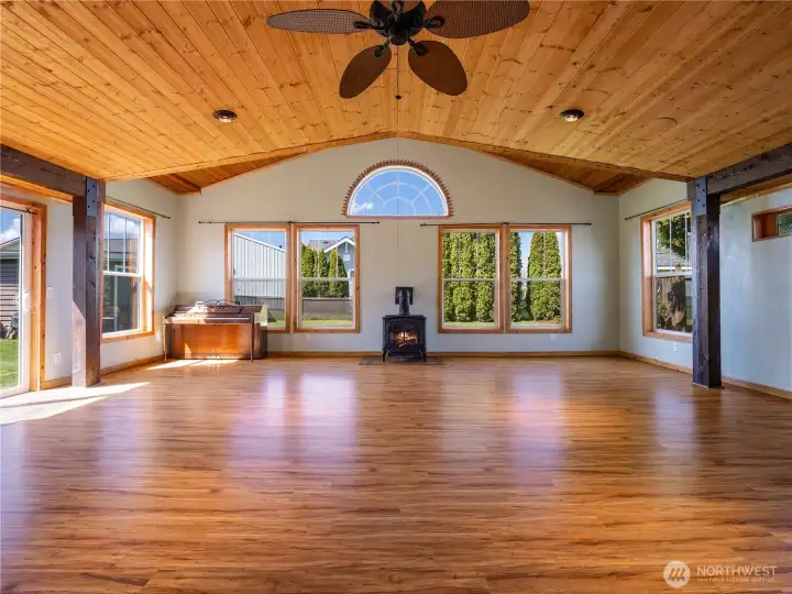 Great room complete with gas fireplace and large windows that fill the space with natural light.
