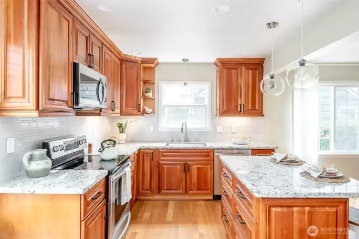 Beautiful cherrywood cabinets frame this kitchen with so much storage space.