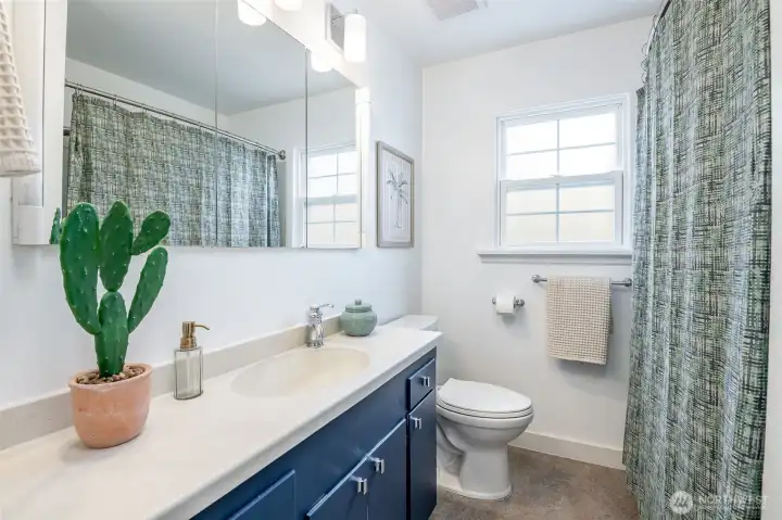 This updated bathroom feels clean and bright, with plenty of storage below.
