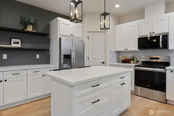 Kitchen has spacious pantry, and lots of cabinet space. Stainless appliances, including the fridge.