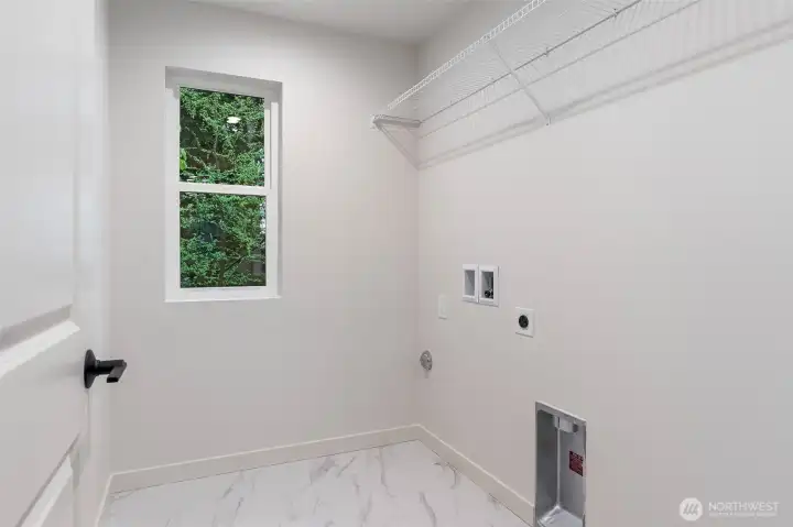 Laundry Room has shelving and tile flooring.