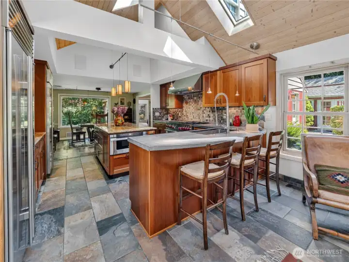 Vaulted kitchen with tile floors.