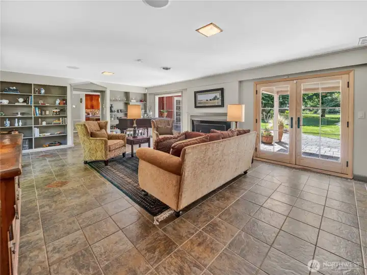 Formal living w/ tile floor & fireplace.