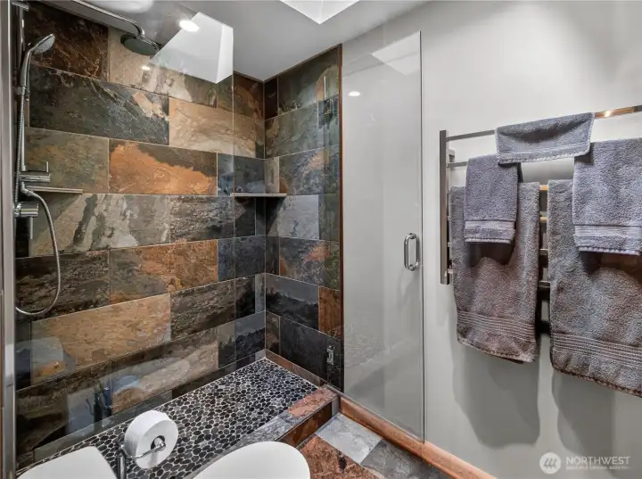 Custom tile shower in the primary full bathroom.