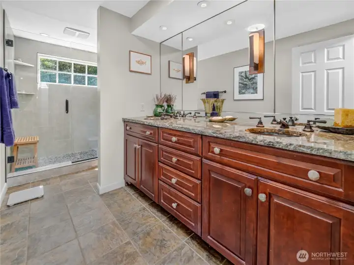 Guest bathroom with dual sink vanity and granite countertops.