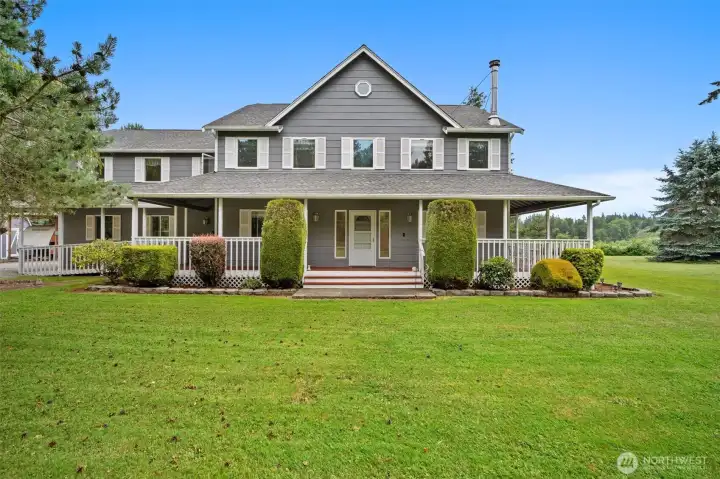 Stately exterior with a welcoming wraparound porch, manicured landscaping, and plenty of outdoor space to enjoy. Stately exterior with a welcoming wraparound porch, manicured landscaping, and plenty of outdoor space to enjoy.