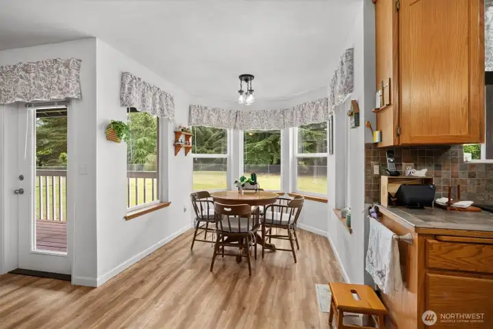Breakfast nook with bay windows overlooking the backyard, offering abundant natural light and seamless access to the outdoor deck. Breakfast nook with bay windows overlooking the backyard, offering abundant natural light and seamless access to the outdoor deck.