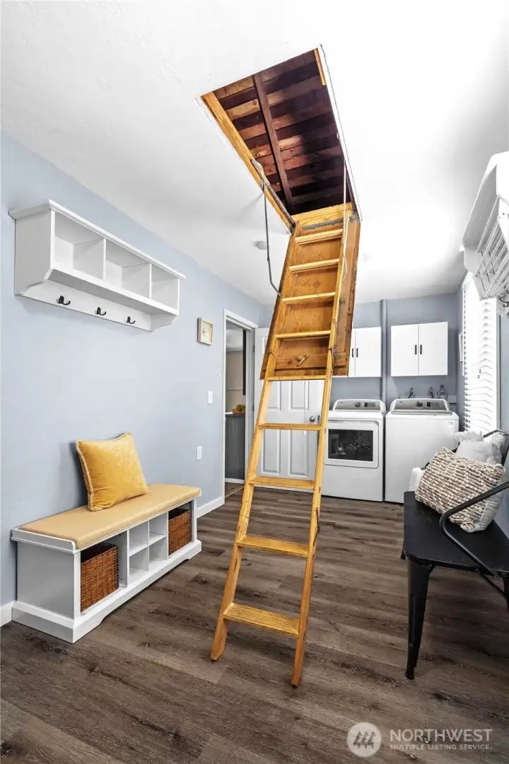 Laundry room has attic storage access with ladder Laundry room has attic storage access with ladder