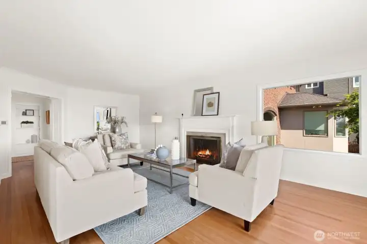 Spacious living room with fire place and lots of natural light. Spacious living room with fire place and lots of natural light.