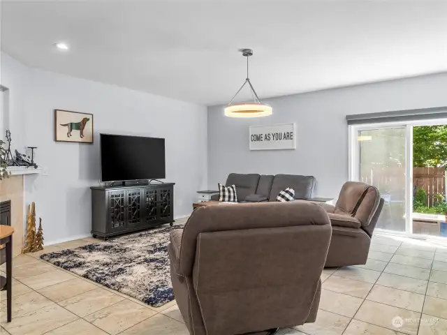 Not just one living space, but two! This one accesses the fabulous rear yard via a slider and has a cozy gas fireplace, high ceilings and a handsome new light fixture. PLUS!  Custom, cordless Bali shade for the slider.