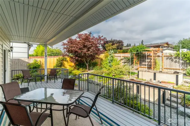 Great covered backyard deck area with aluminum railings, beautiful outdoor decking that is perfect for year round enjoyment! Nice and private feel! All 6 chairs, glass table and matching end table stay with the house!