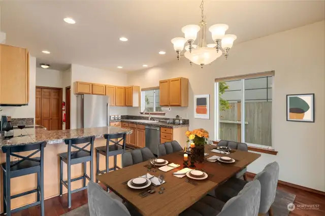 Open area from the dining room to the open kitchen with high ceilings. Virtually staged.