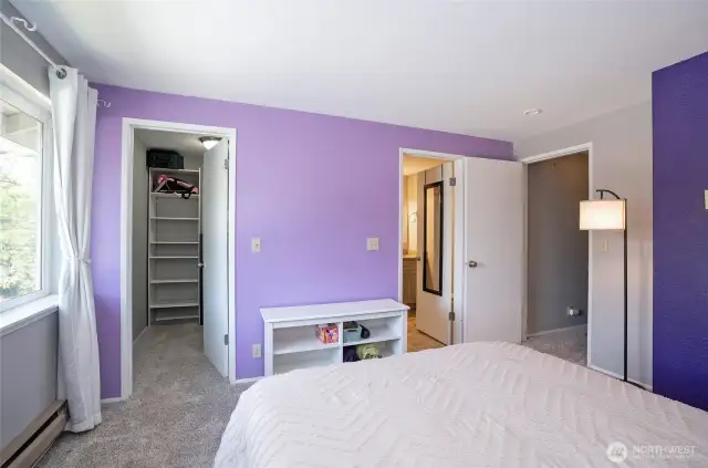 The primary suite features a walk-in closet to the left and a private en-suite bath to the right, offering both comfort and convenience.