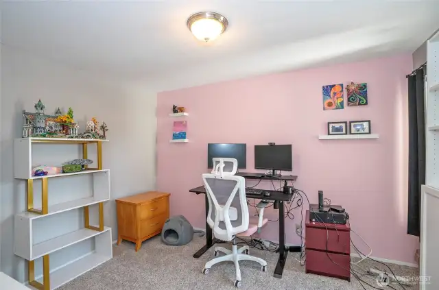 This guest suite, perfect for overnight visitors, is currently being used as a functional home office.