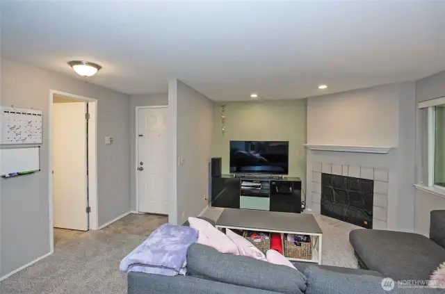 The living area offers a charming wood-burning fireplace, adding warmth and comfort to the space.