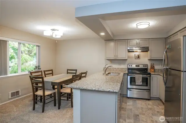 Kitchen features stainless steel appliances and sleek granite countertops for a modern, functional space.
