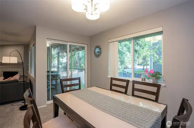 Dining area with a sliding door that opens to the private deck, offering easy access to outdoor relaxation and entertaining.