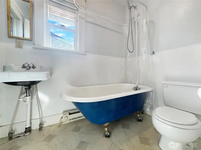 Tall ceilings, rich trim details, classic cabinetry, vintage clawfoot tub, and timeless charm