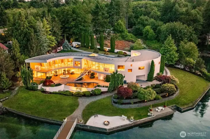 An Icon Revealed – The S House on Wollochet Bay. This architectural tour de force curves along 335’ of private waterfront, showcasing its signature S-shaped design, two stories of glass, and rare deepwater dock. A one-of-a-kind Gig Harbor estate where light, water, and luxury converge