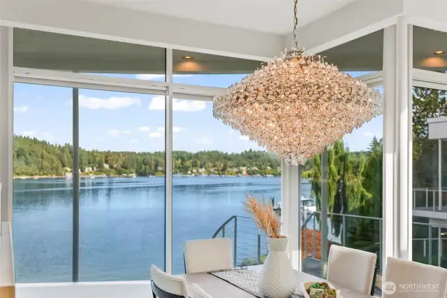 Dine beneath a dazzling crystal chandelier as floor-to-ceiling glass frames serene Wollochet Bay views — every meal here feels like a celebration