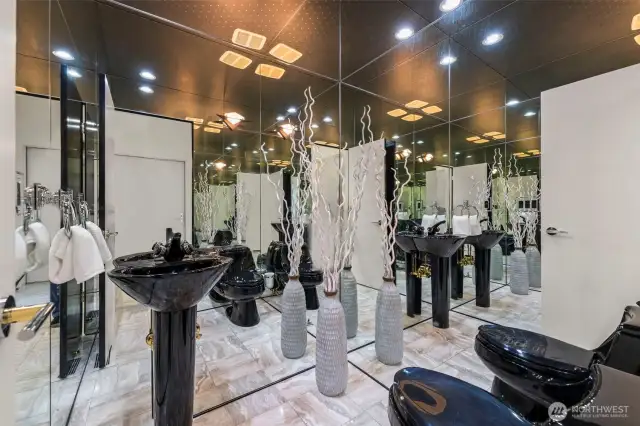 This is not your every day powder room!  Striking black fixtures and mirroed walls give this a bold, glamorous edge.