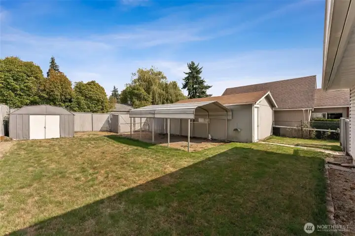 Large Backyard with shed, canopy, and detached 1-car garage
