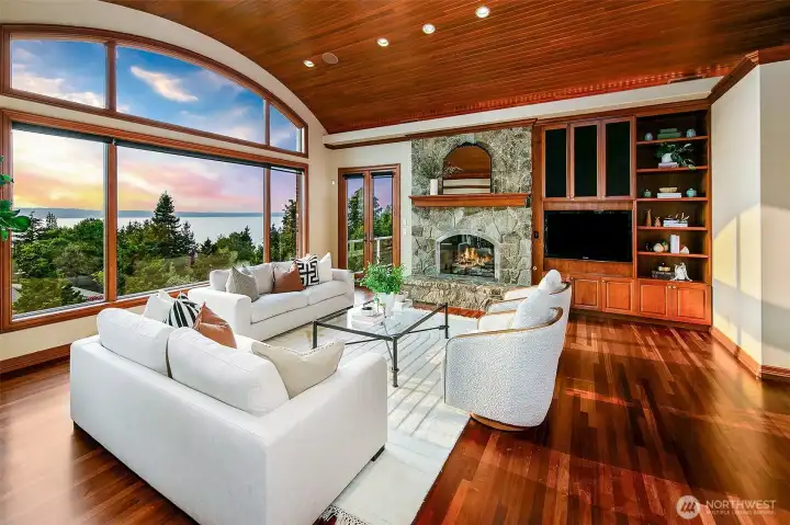 anchored by a cozy rock fireplace and decks flagging each side of the room