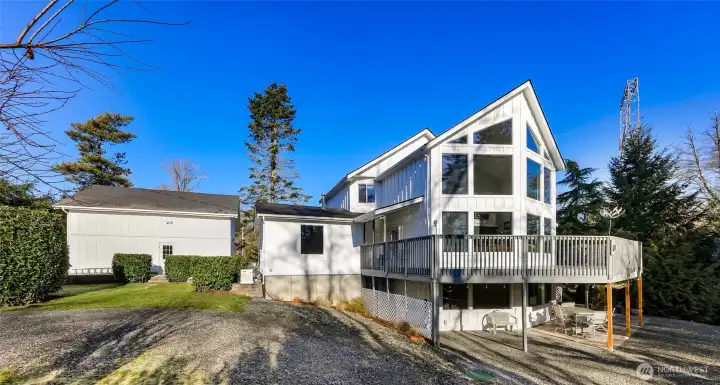 Wrap around porch also provides covered space below for year round enjoyment.
