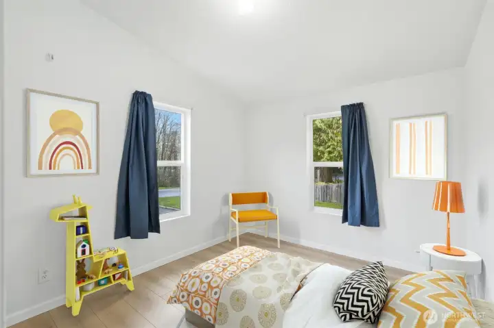 Virtually staged second bedroom demonstrating versatility for guests, a home office, or hobby space.