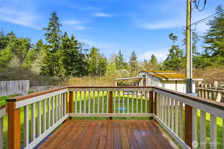Rear deck overlooking the yard, perfect for outdoor relaxation.