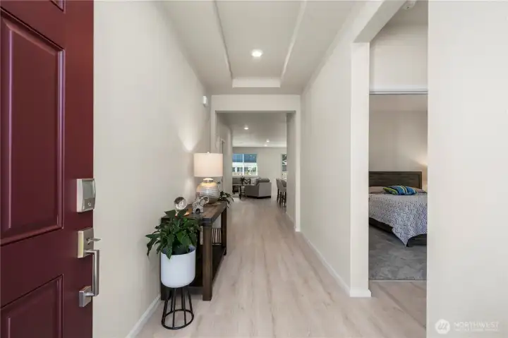 Hallway with view of the great room ahead. To the right are 2 bedrooms and the hallway bath.