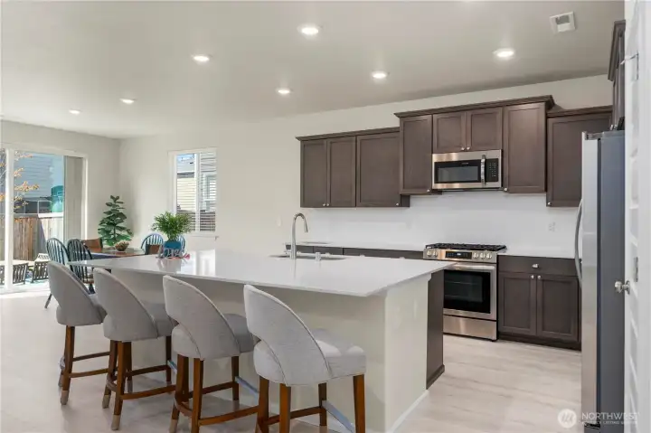 Kitchen with large center island, quartz countertops.