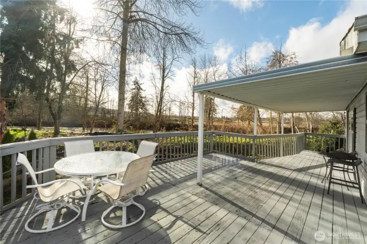 A riverside deck designed for relaxing outdoors while enjoying the gentle flow of the river.